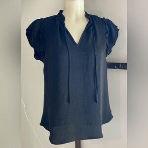 Black easy flow top with short flutter sleeves ties at neck.
